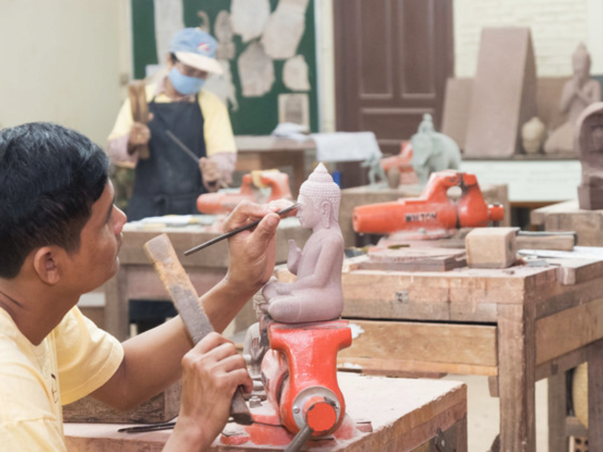 Artisans creating Buddha sculptures in Angkor Siem Reap, Cambodia