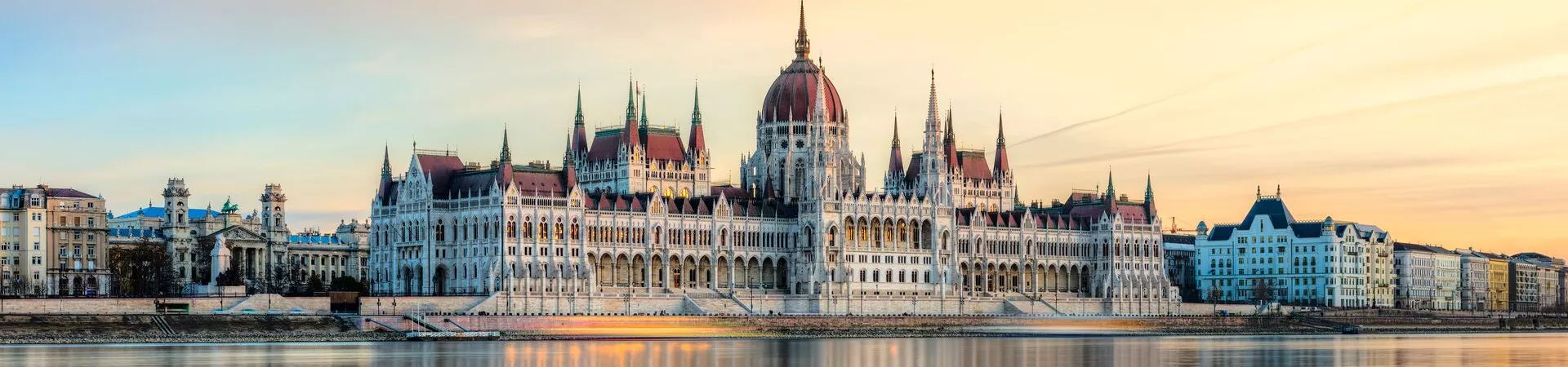 Hungarian Parliament in Budapest, reflected in a beautiful orange-hued river