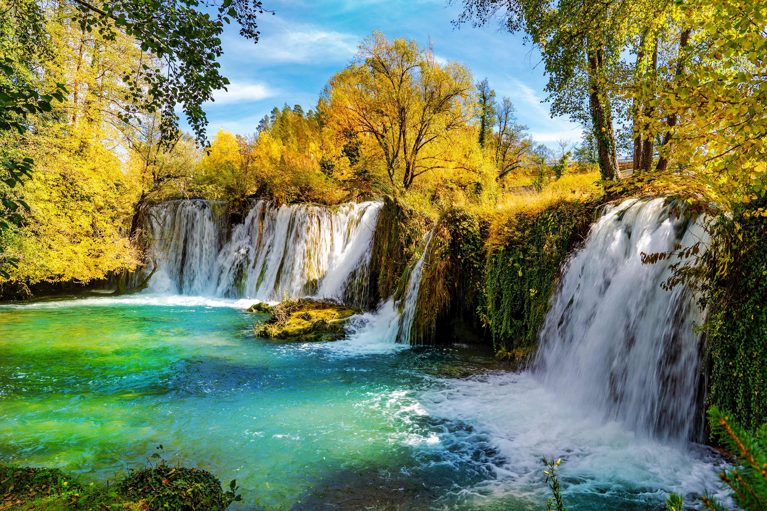 Waterfalls surrounded by autumn trees in Plitvice, Croatia