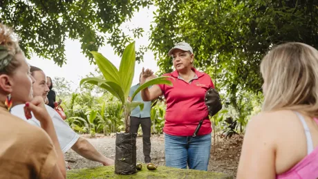 Woman Guiding In Front Of A Group Of People
