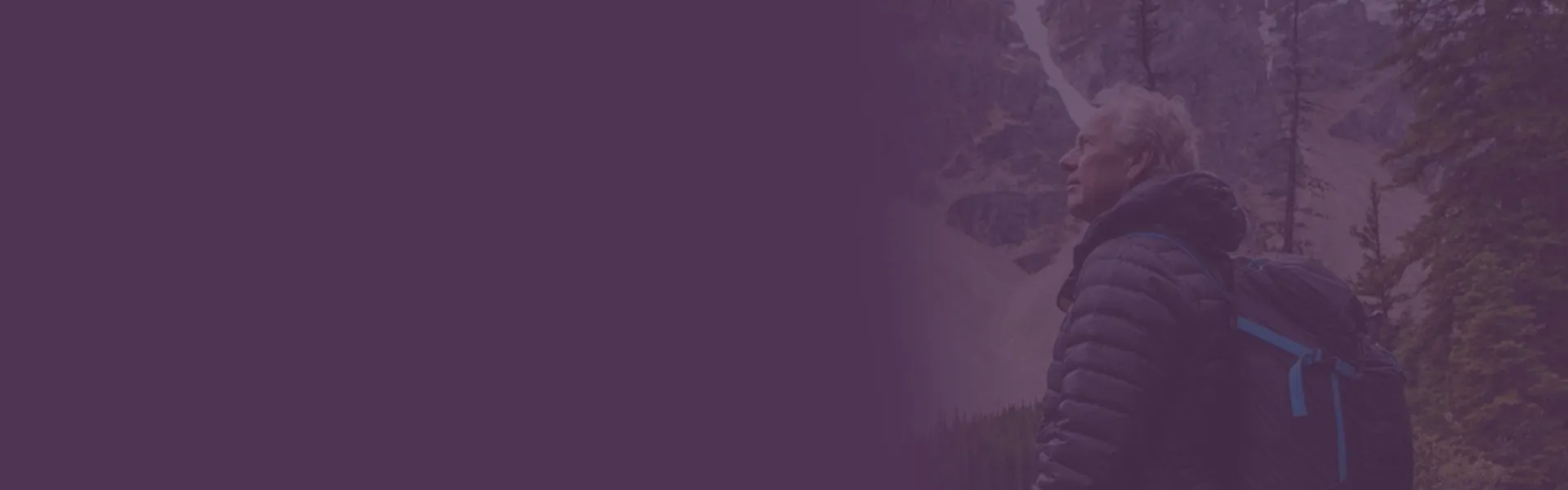 A man in a black jacket with a purple background