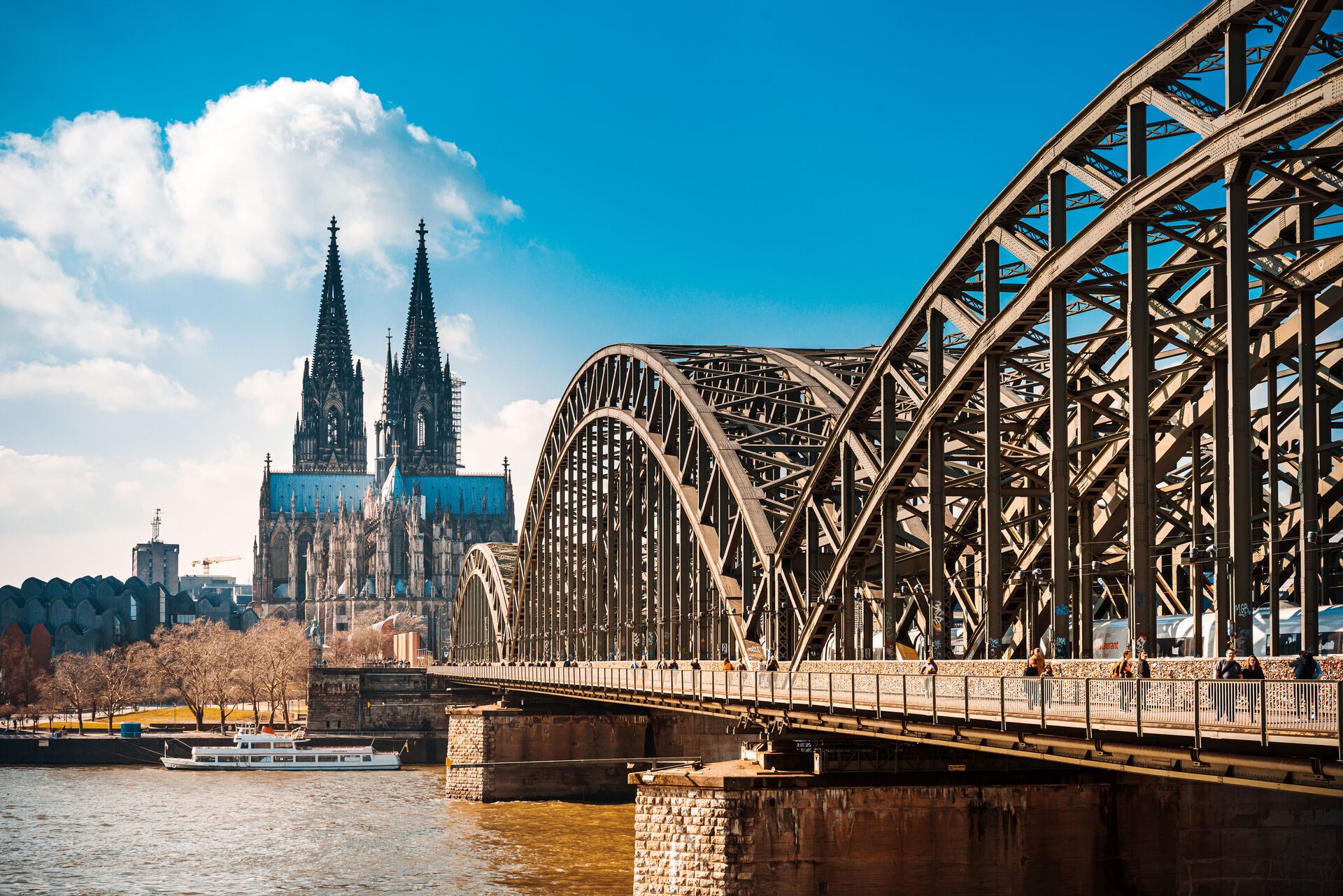 Cologne Cathedral with Cologne Bridge in the foreground on a sunny day in Cologne, Germany