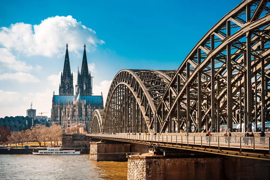 Cologne Cathedral with Cologne Bridge in the foreground on a sunny day in Cologne, Germany