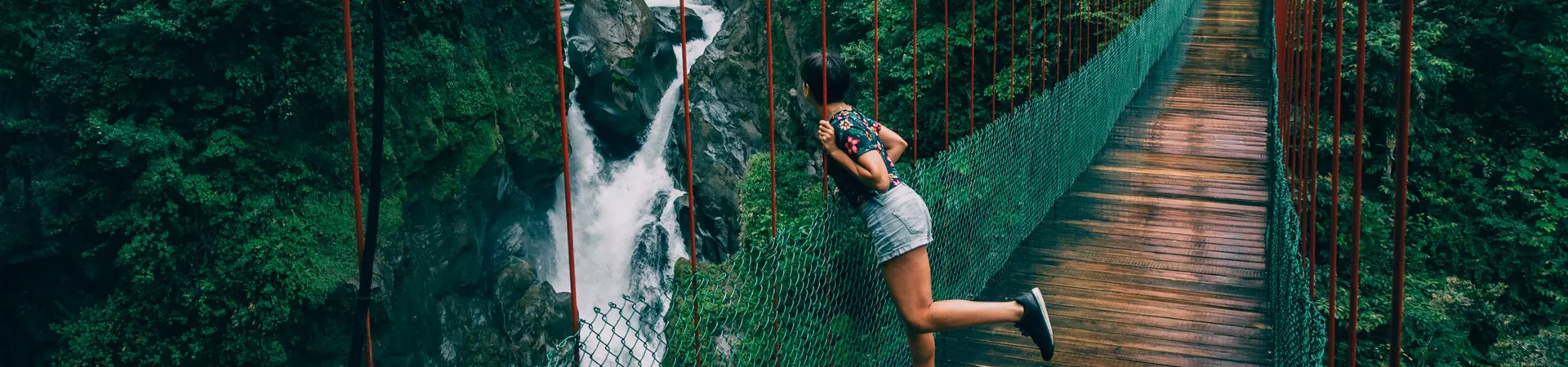 Young woman looking to a waterfall