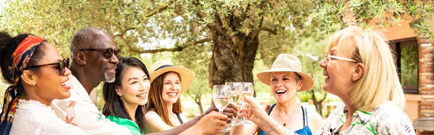 Guests holding up drinks at a Be My Guest experience