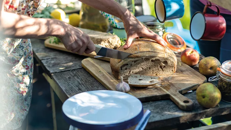 A woman cutting homemade bread