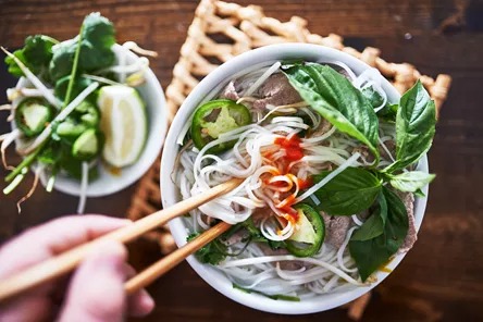vietnamese-pho-with-spicy-sriracha-sauce-shot-top-down-503129686.jpeg
