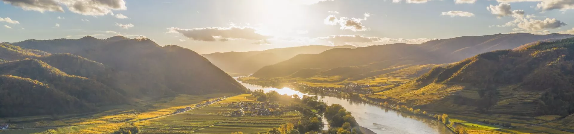 Aerial shot of the Wachau Valley, with the sun reflecting off the River Danube