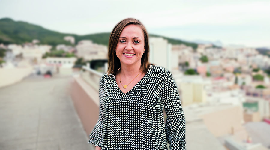 Travel Director Kassie stood in front of cityscape