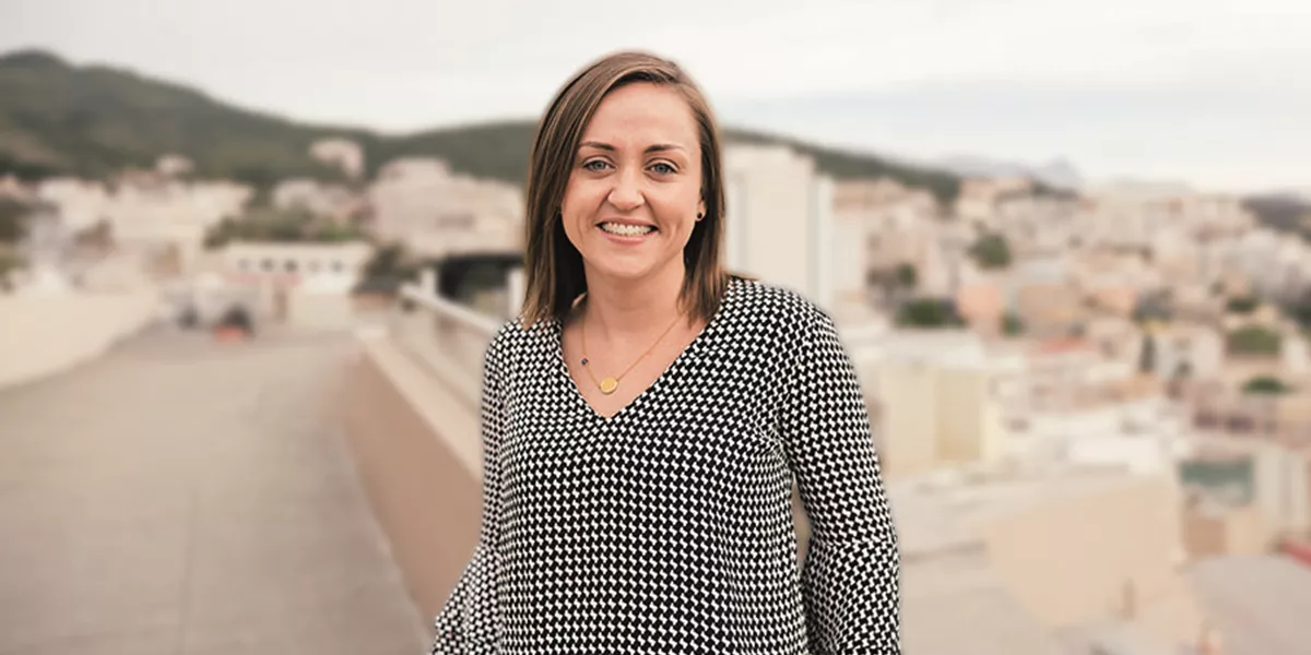 Travel Director Kassie stood in front of cityscape