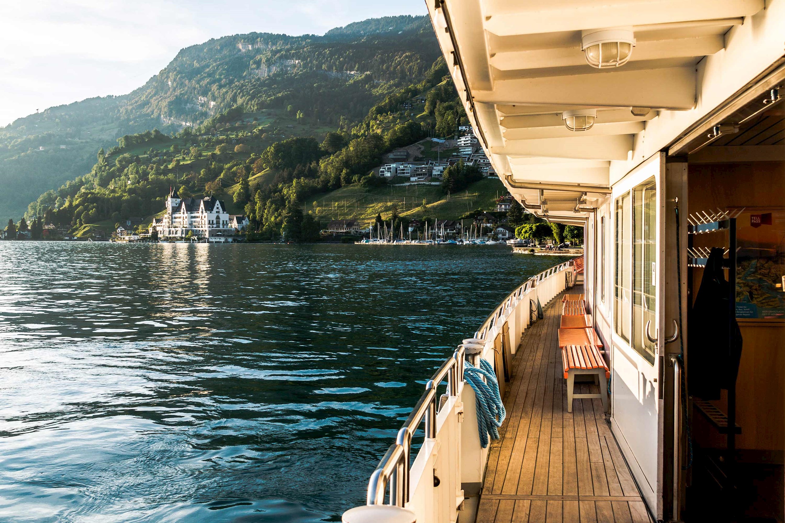 Boat approaching Vitznau on Lake Lucerne with Swiss Alps in Switzerland