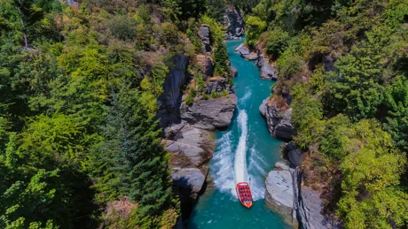 Boat going down Shotover River in New Zeland