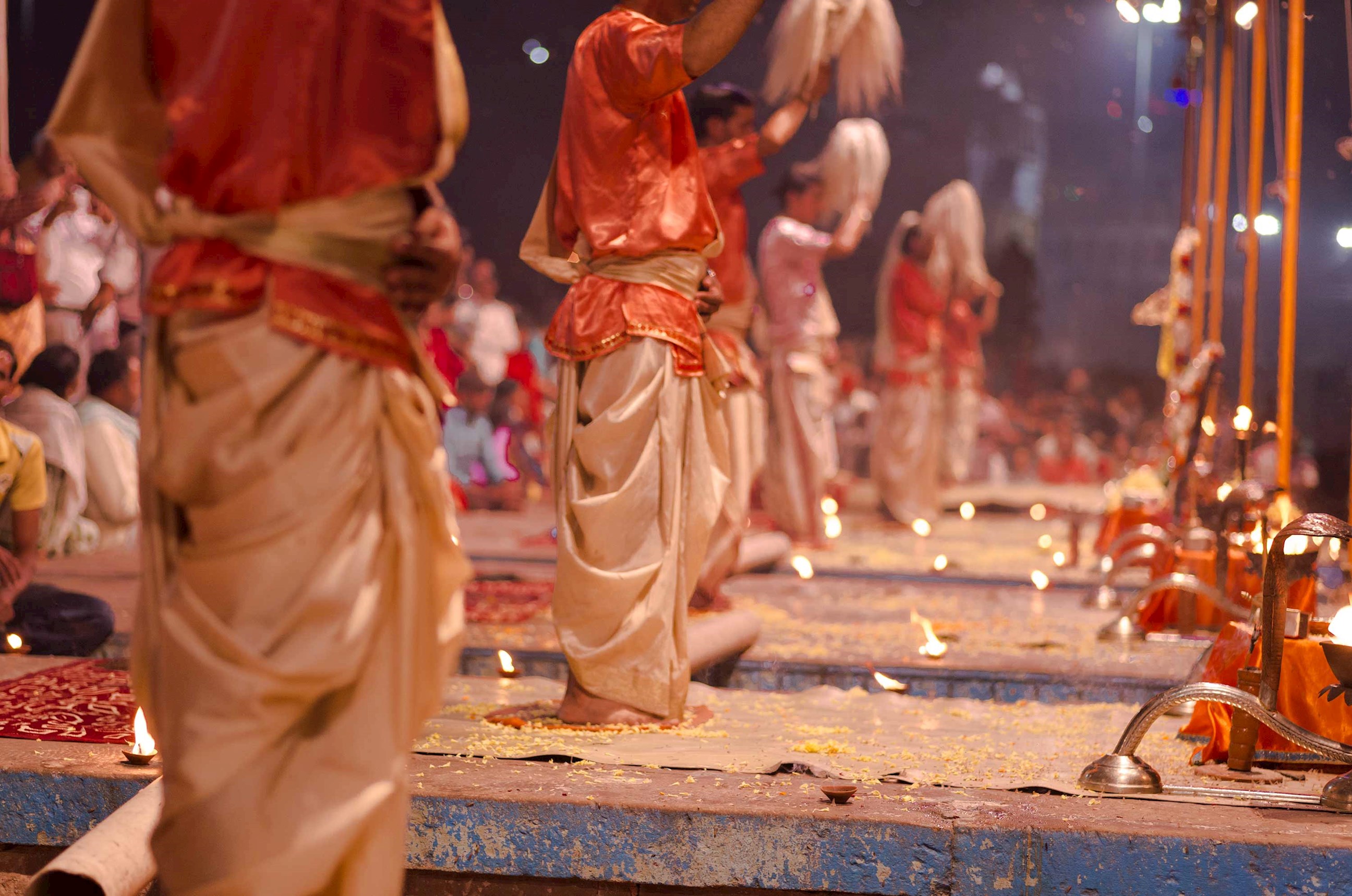Hindu priests performing evening Ganga Aarti ceremony with lamps and rituals, Delhi, India