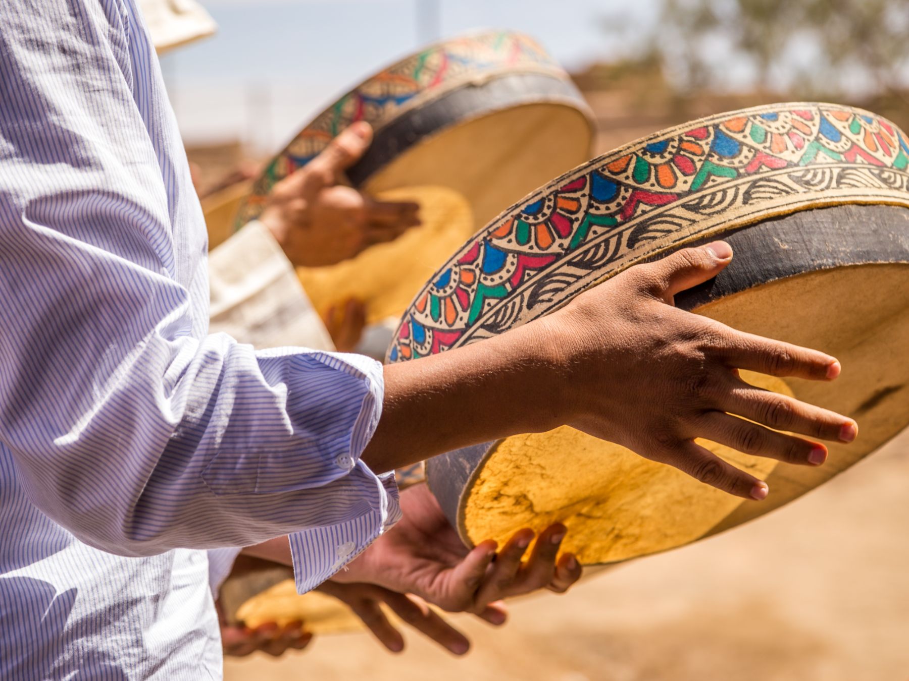 Person playing traditional tambourine on Merzouga Desert in Morocco