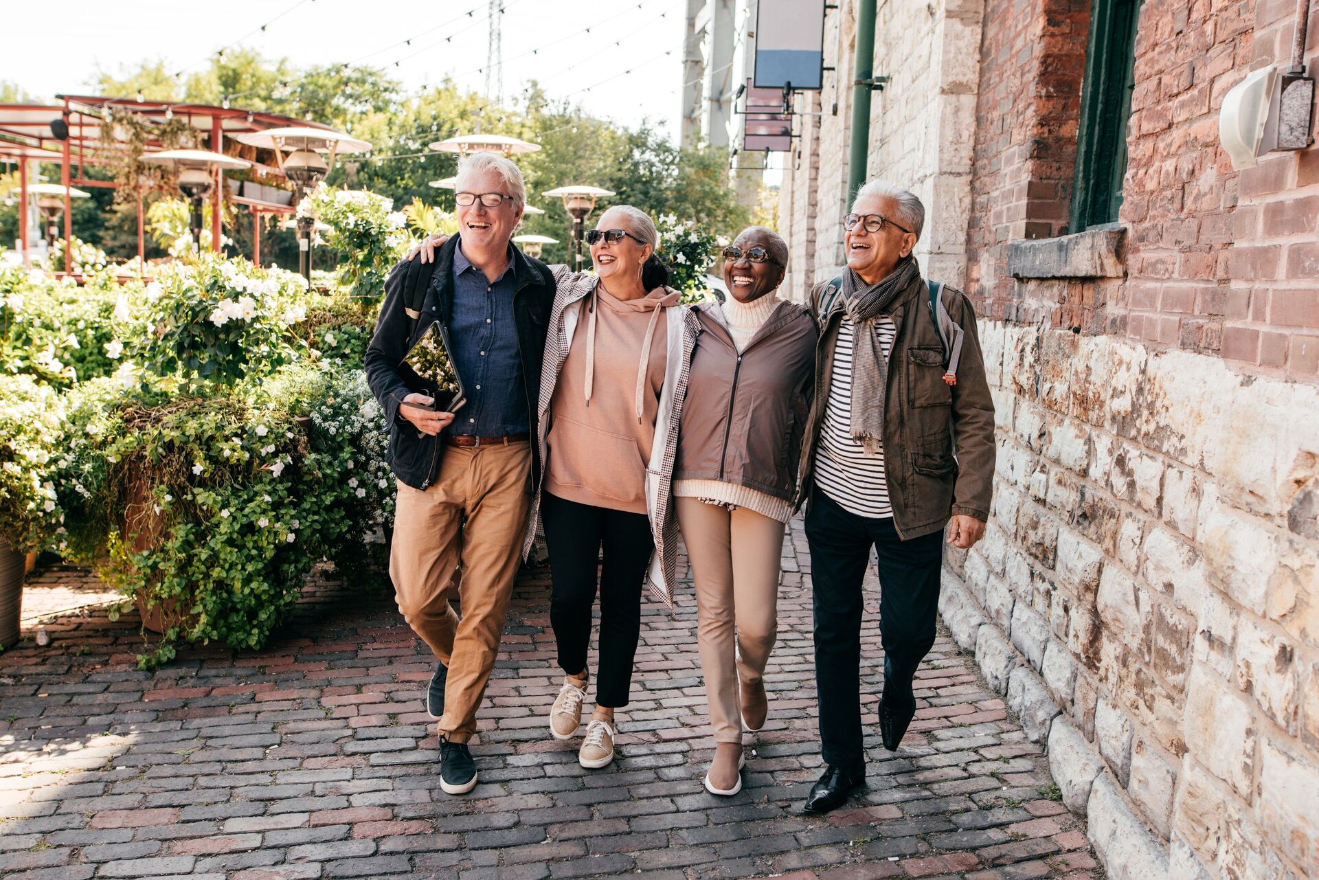 Group of older tourists laughing while walking around a European city