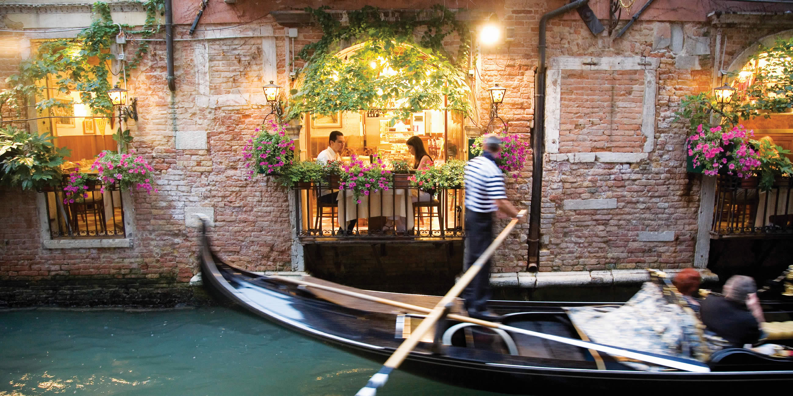 Gondola passing restaurant, Italy 