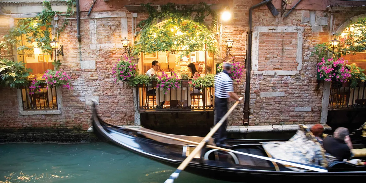 Gondola passing restaurant, Italy