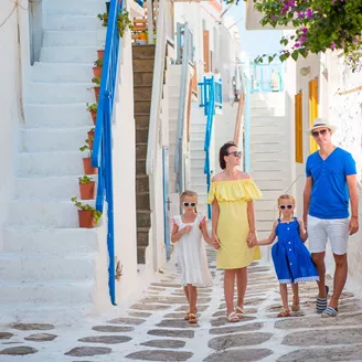 Family of 4 exploring the beautiful island of Mykonos in Greece while on a summer holiday