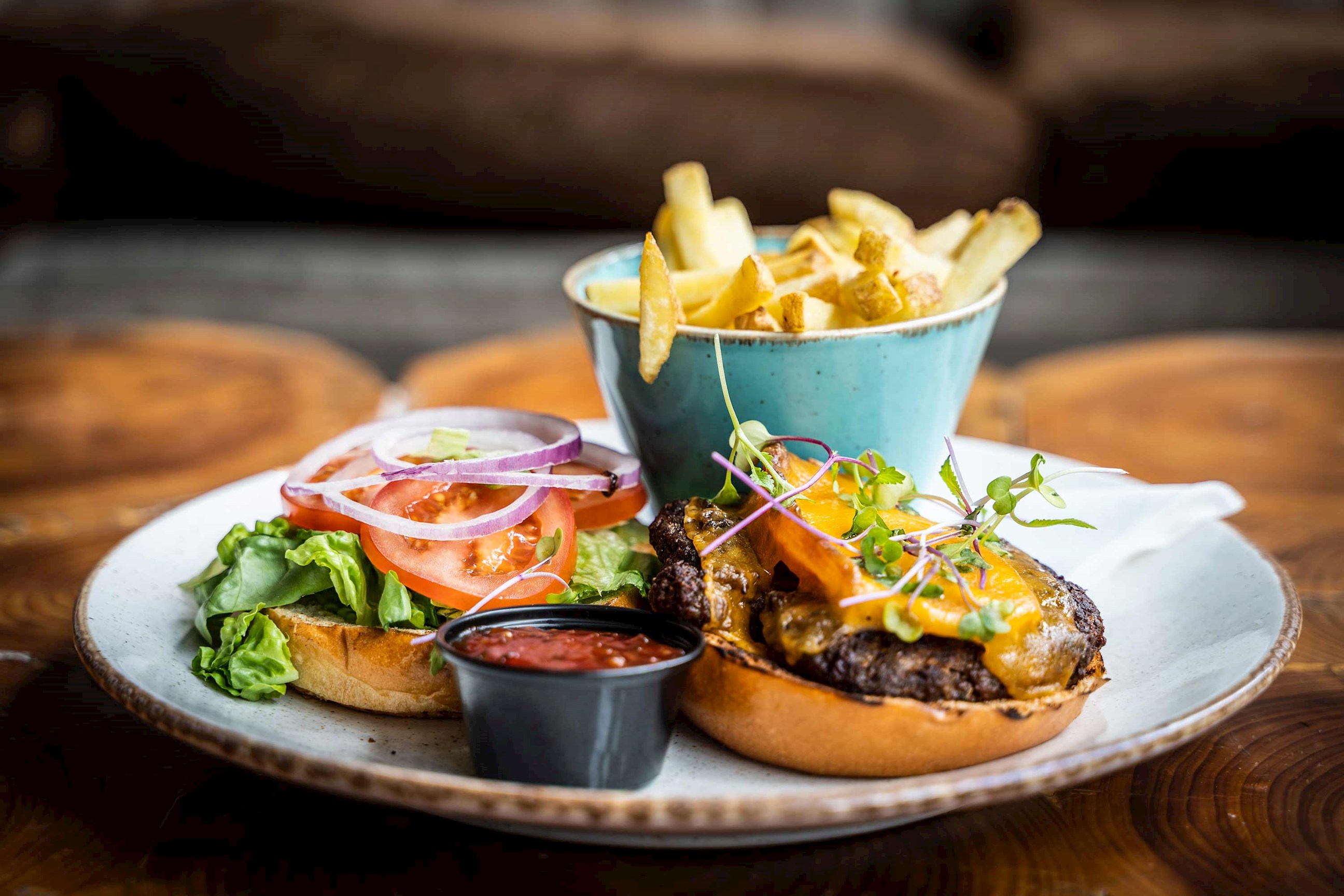 A plate featuring an open burger and fries in Glasgow, Scotland