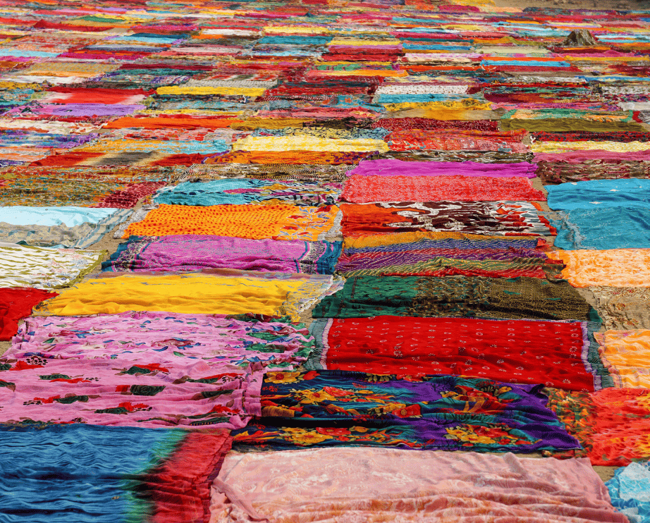 Colorful fabrics and textiles spread out in rows