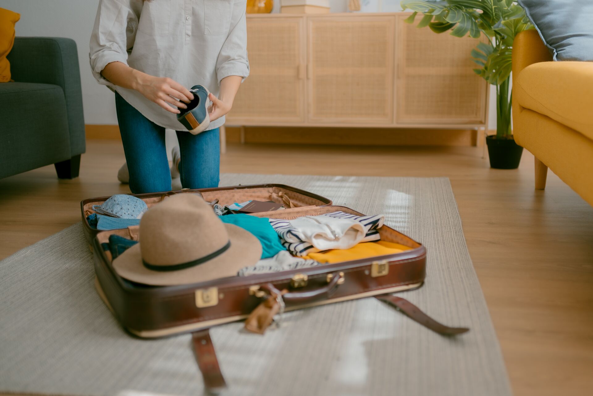 Close-up of young woman packing for an upcoming trip 