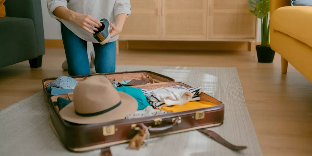 Close-up of young woman packing for an upcoming trip