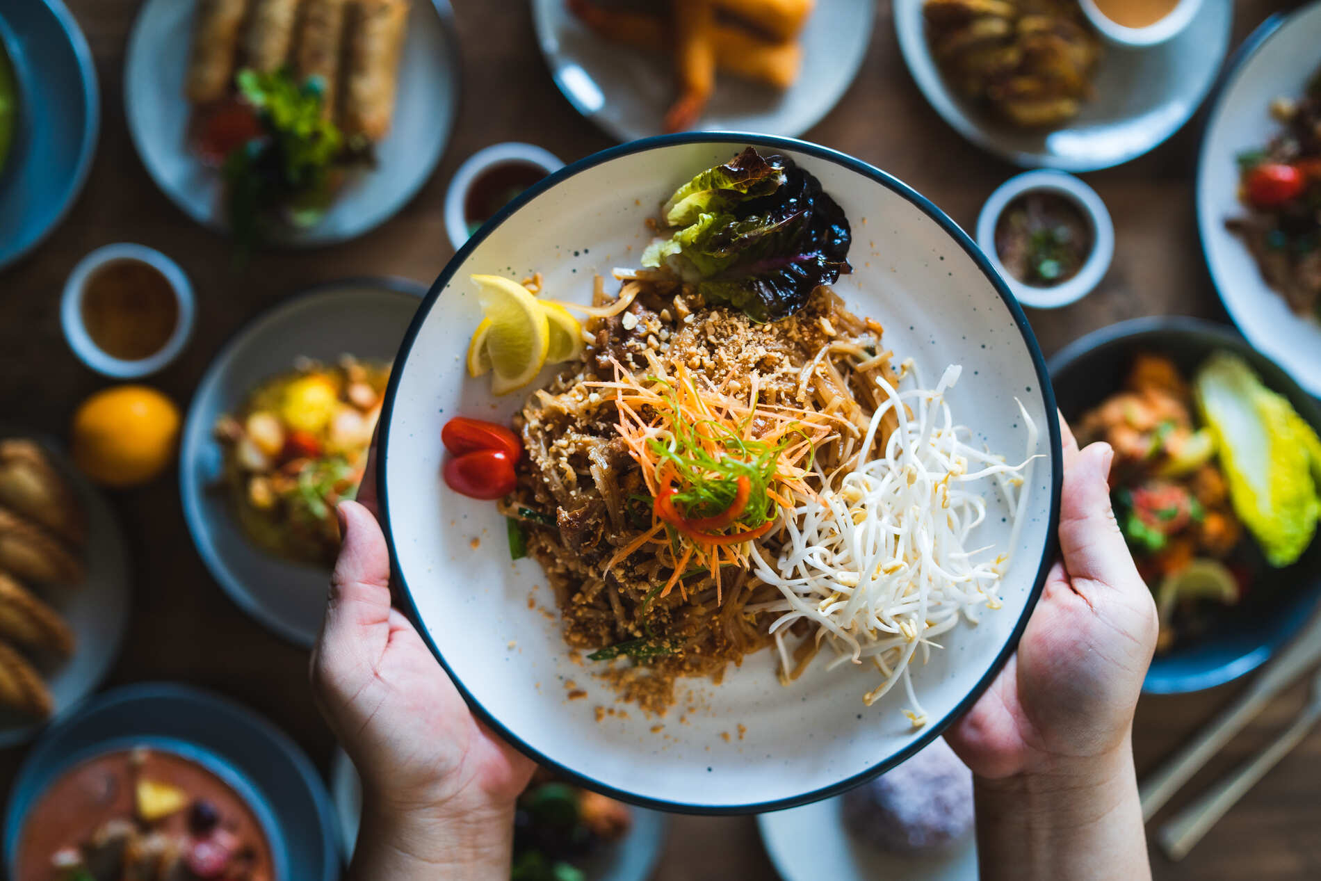 Hands holding up a dish of food