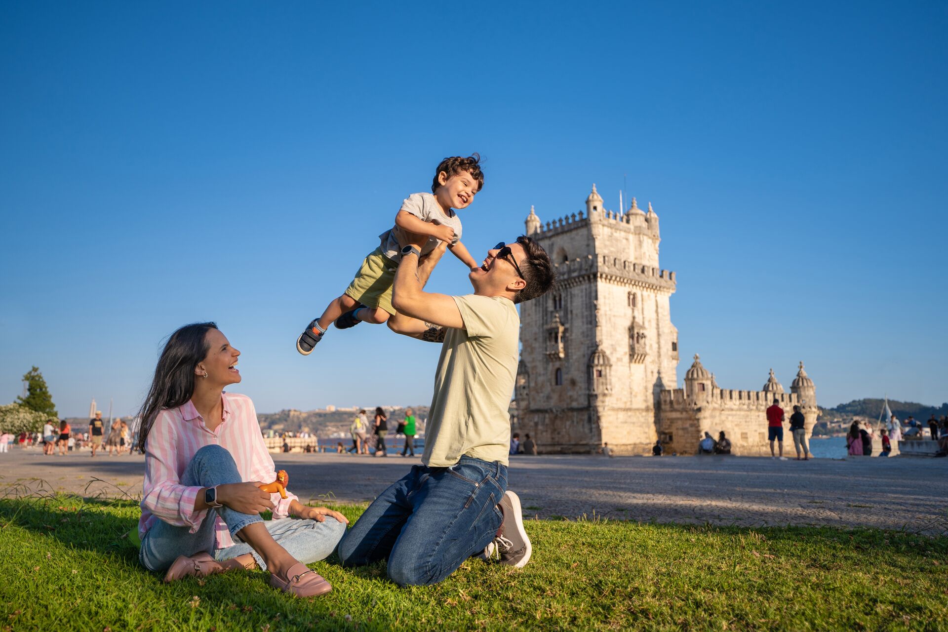 Family paying in front of Belém Tower in Lisbon, Portugal