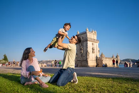 Family paying in front of Belém Tower in Lisbon, Portugal