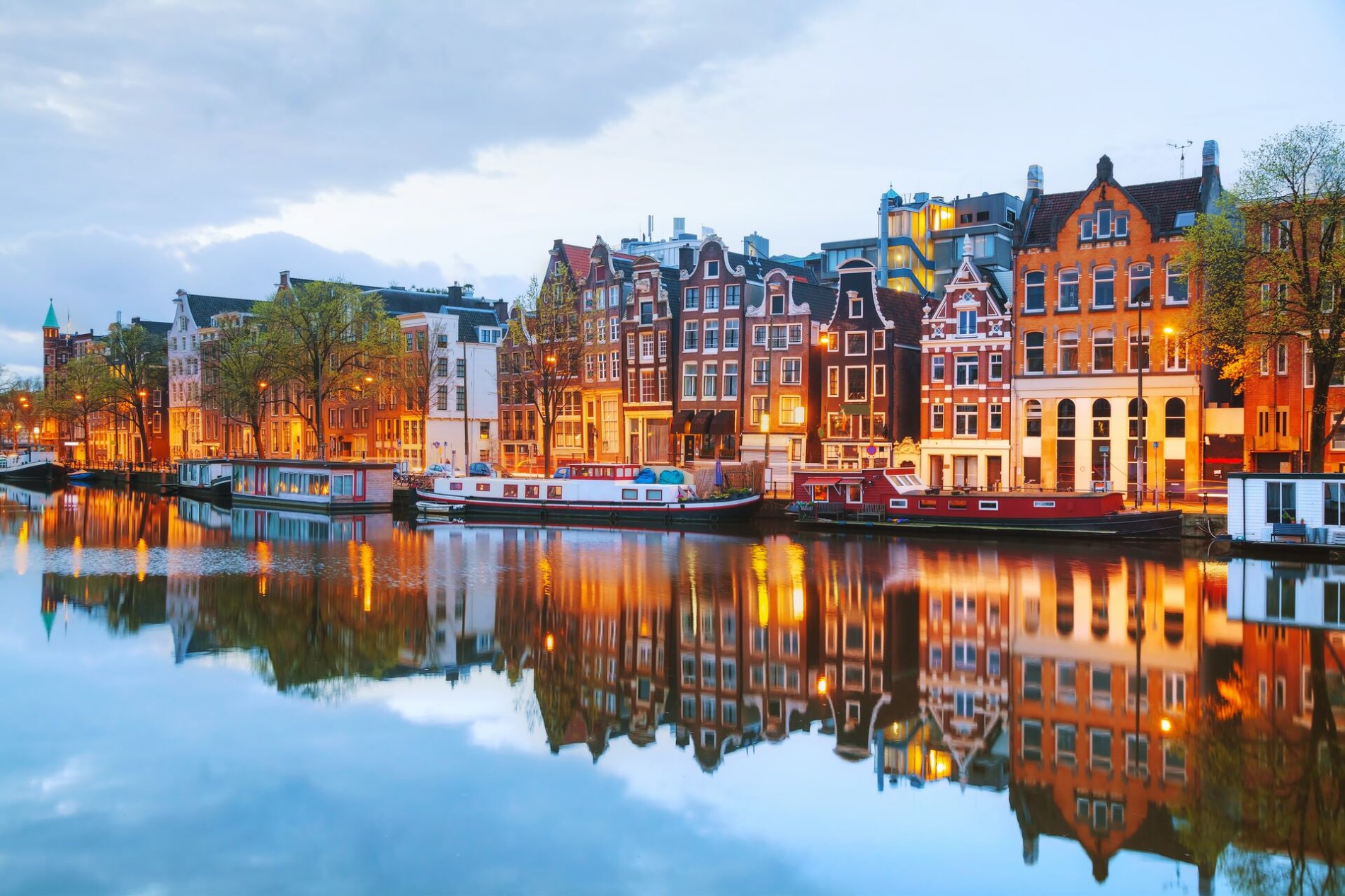 Night Amsterdam with canals and boats in The Netherlands