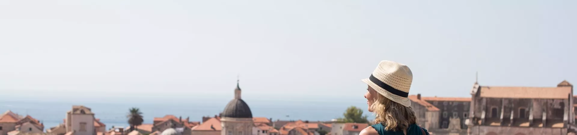 A woman walking on a city wall in Dubrovnik, Croatia