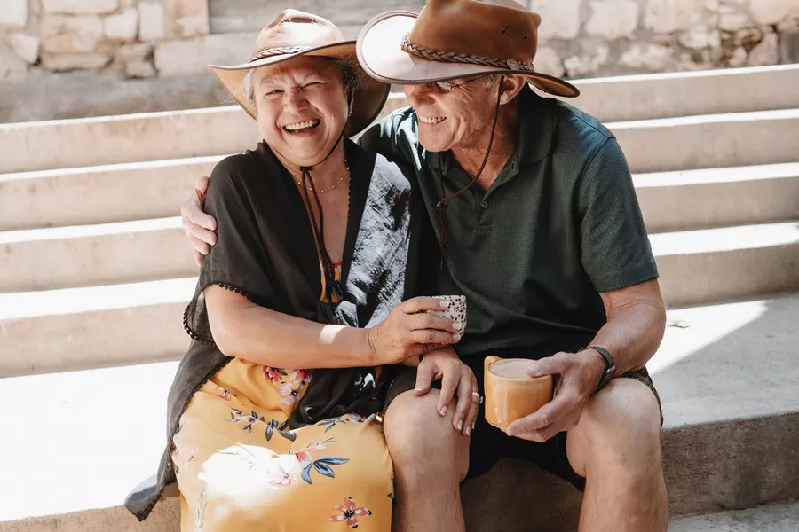 Couple smiling while sitting on the steps