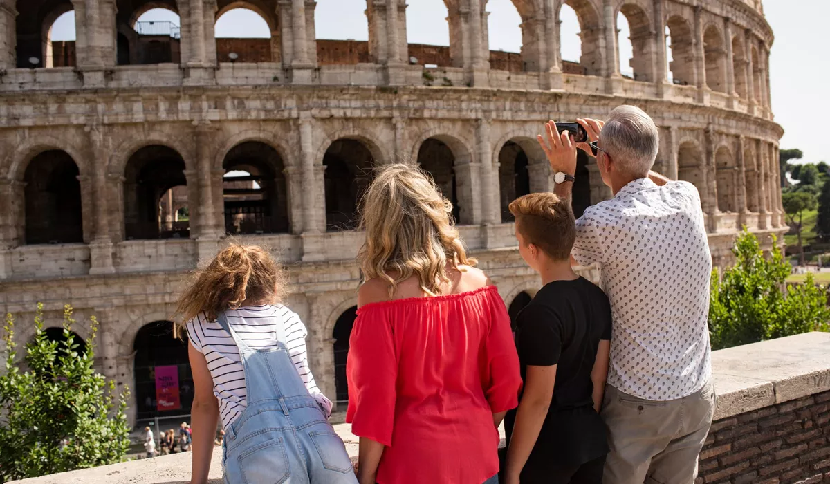 Family taking photos of the Colosseum in Rome, Italy