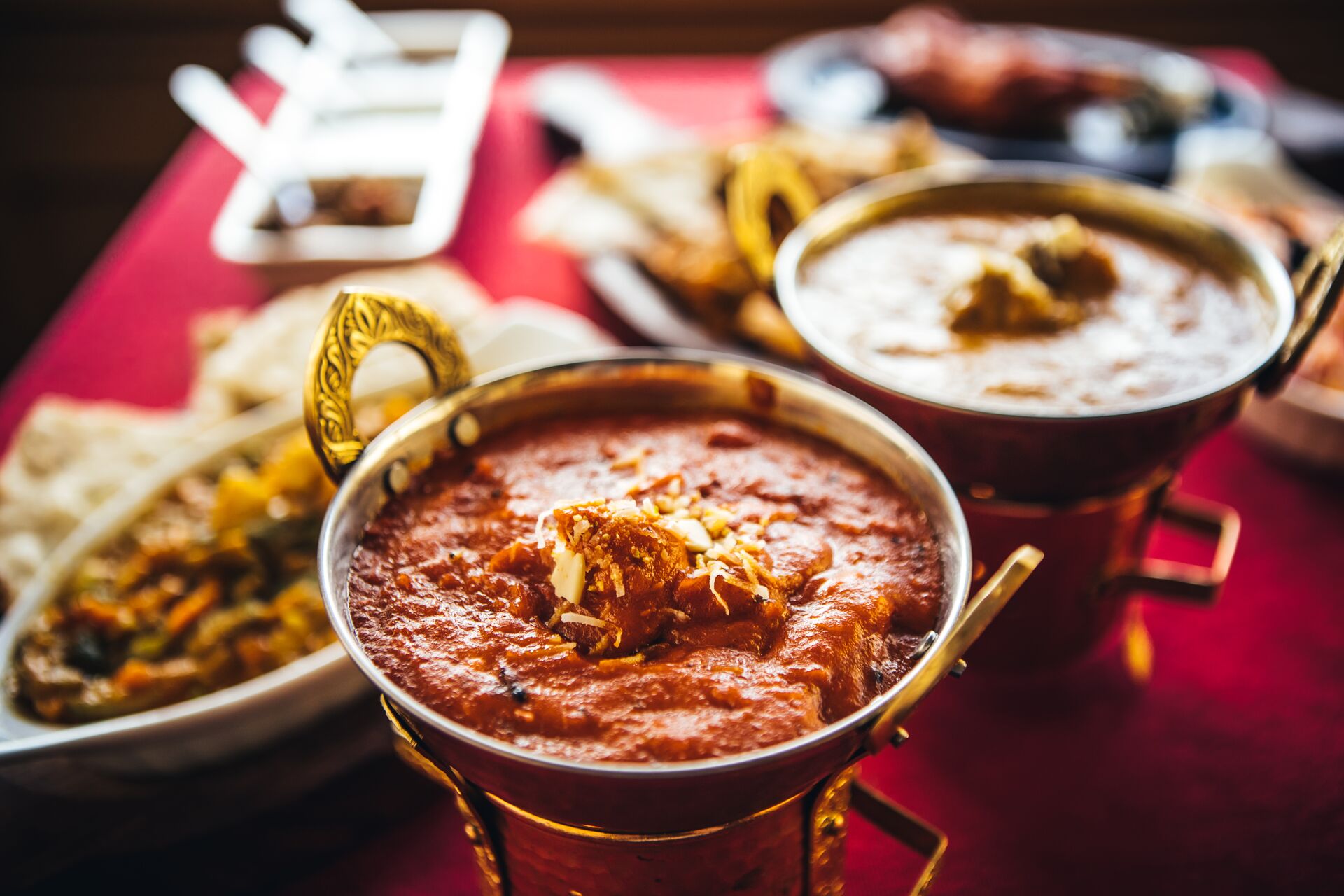 Indian Cuisine Feast With Curry, Samosas, Naan Bread And Basmati Rice On A Table 