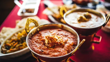Indian Cuisine Feast With Curry, Samosas, Naan Bread And Basmati Rice On A Table