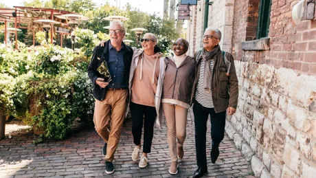 A group of senior people walking and smiling