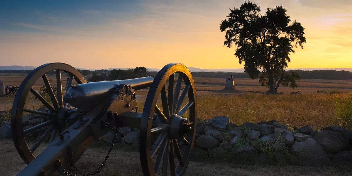 Cannon on a battlefield at dusk