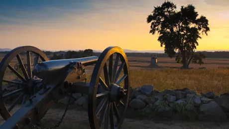 Cannon on a battlefield at dusk