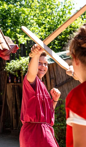 Children playing fighting at a Gladiator School in Rome, Italy