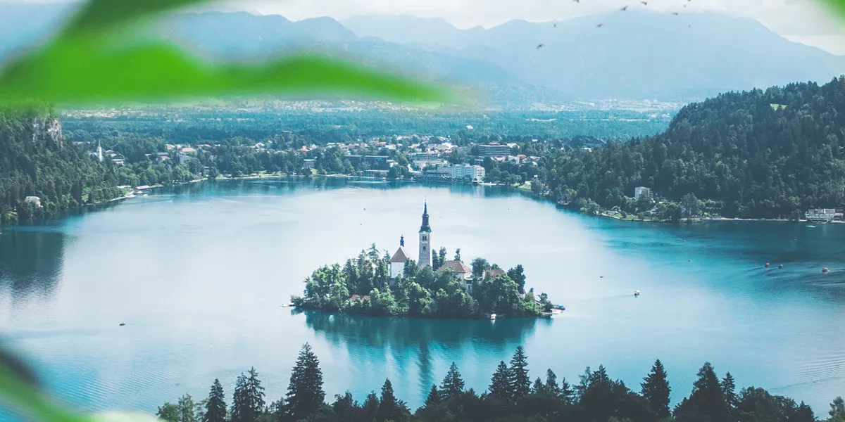 An island with a tower in the middle of Lake Bled in Slovenia