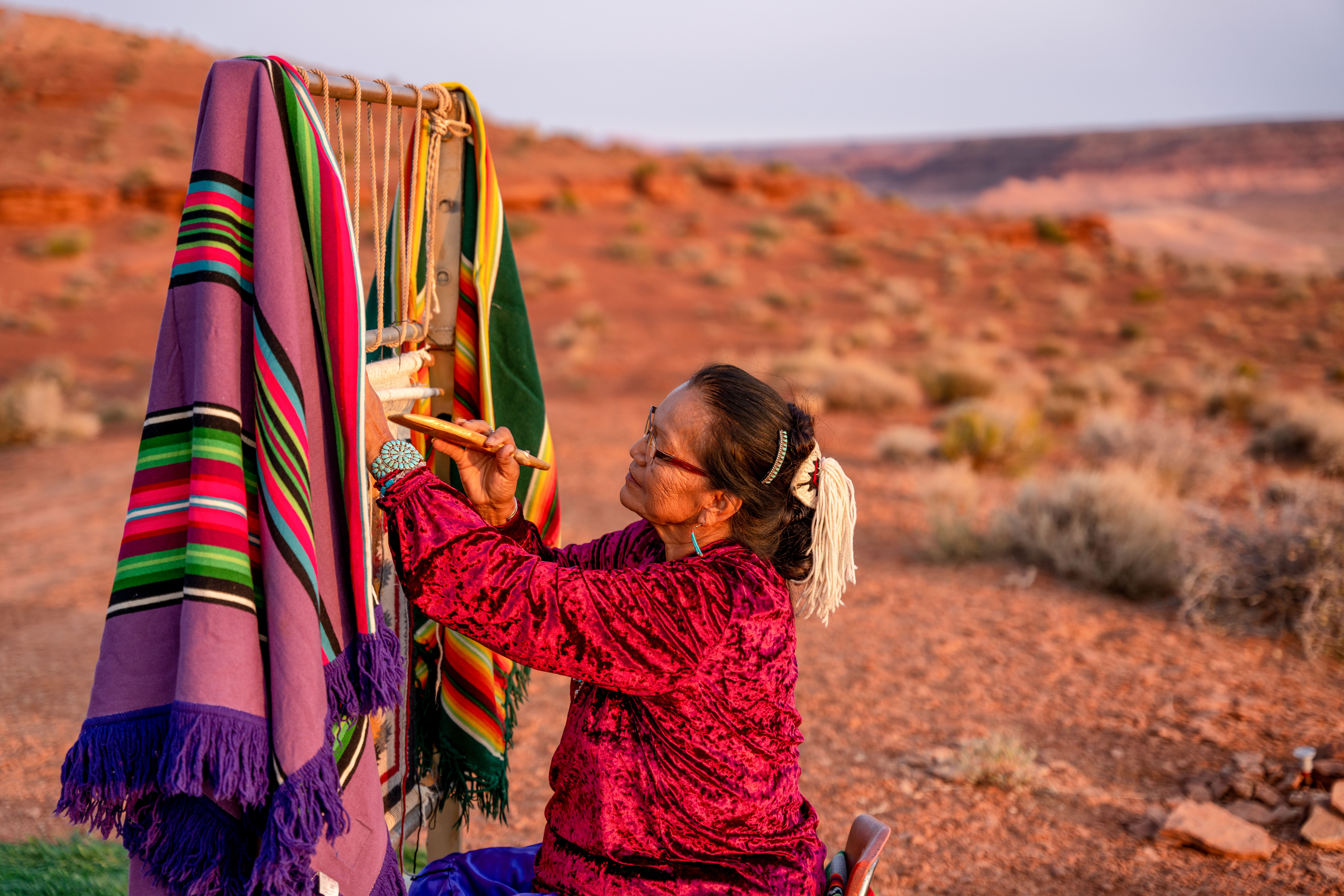 Elderly Navajo Woman Weaving A Traditional Blanket Or Rug