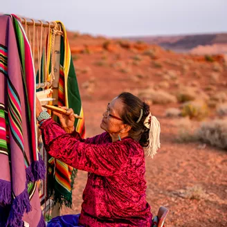 Elderly Navajo Woman Weaving A Traditional Blanket Or Rug