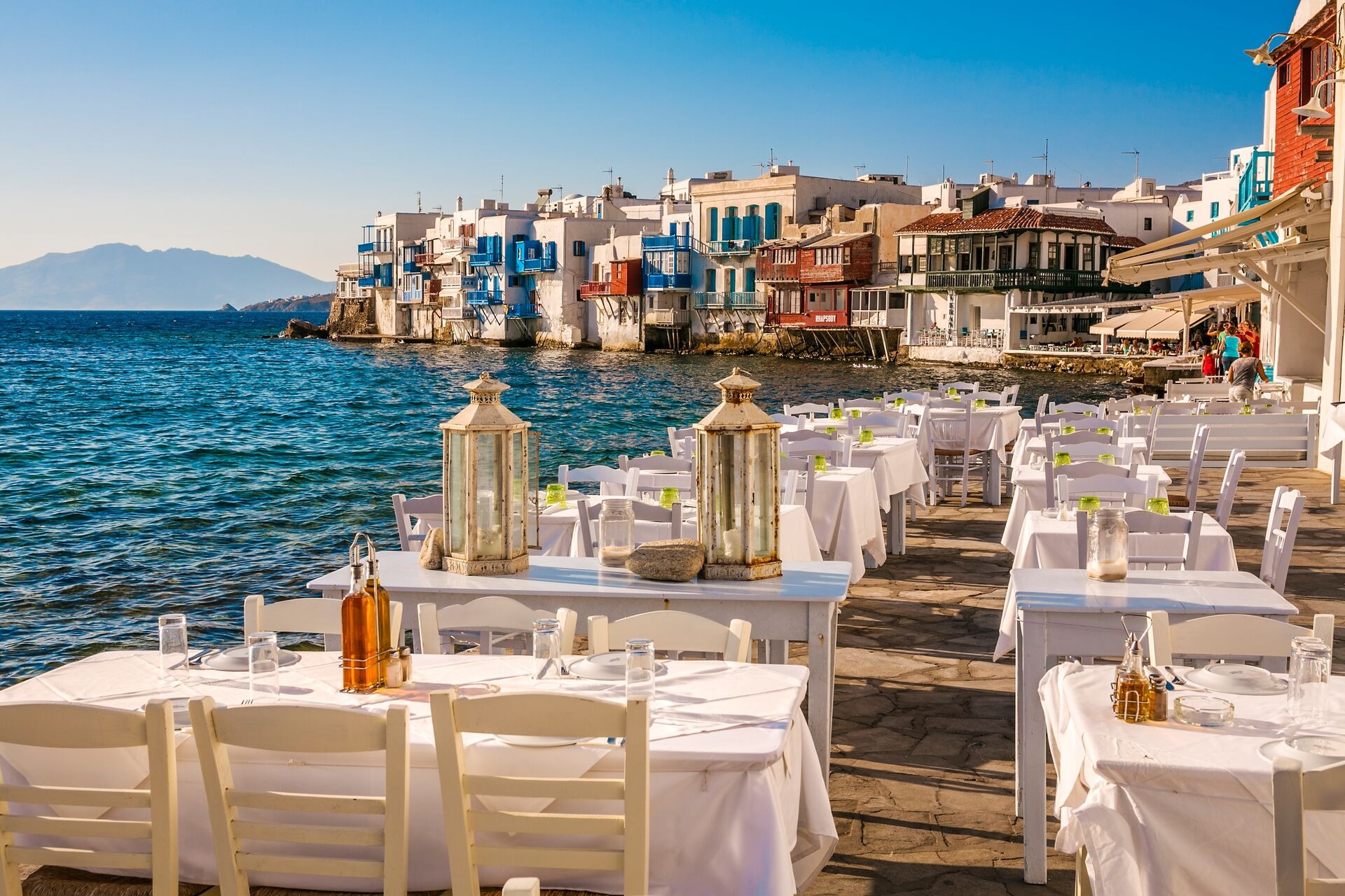 Restaurant tables on seaview terrace in Little Venice At Mykonos Town in Greece
