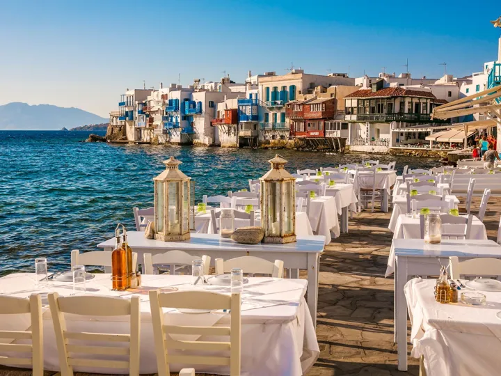 Restaurant tables on seaview terrace in Little Venice At Mykonos Town in Greece