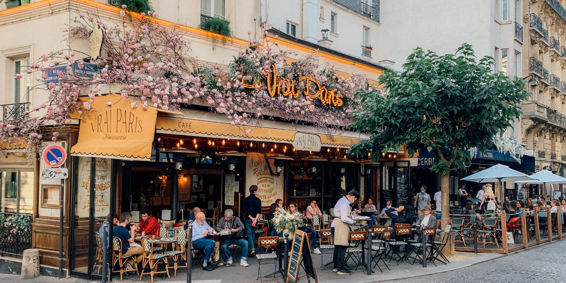 Restaurant Le Vrai Paris with outside tables and flower decorations in Paris, France