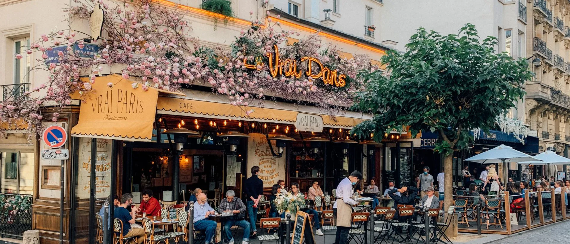 Restaurant Le Vrai Paris with outside tables and flower decorations in Paris, France
