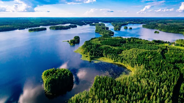 Aerial view of blue lakes and green forests on a sunny summer day in Finland, Europe