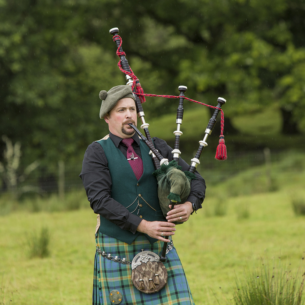 A man playing bagpipes in Scotland