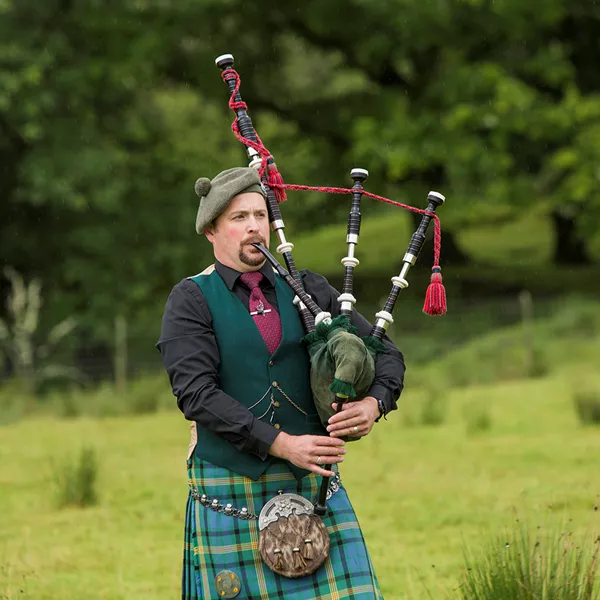 A man playing bagpipes in Scotland
