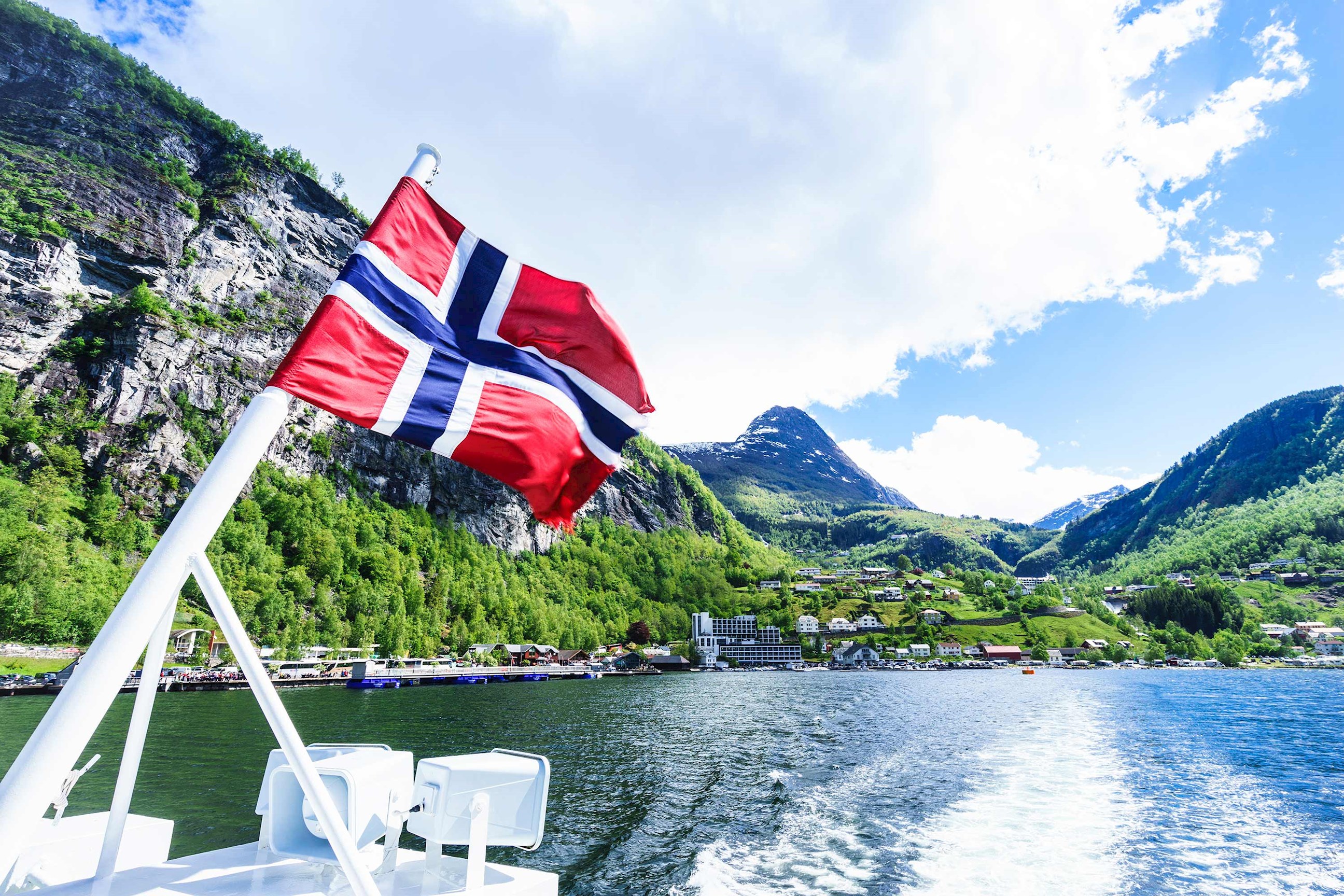 A Norwegian flag sailing over Naeroyfjord  